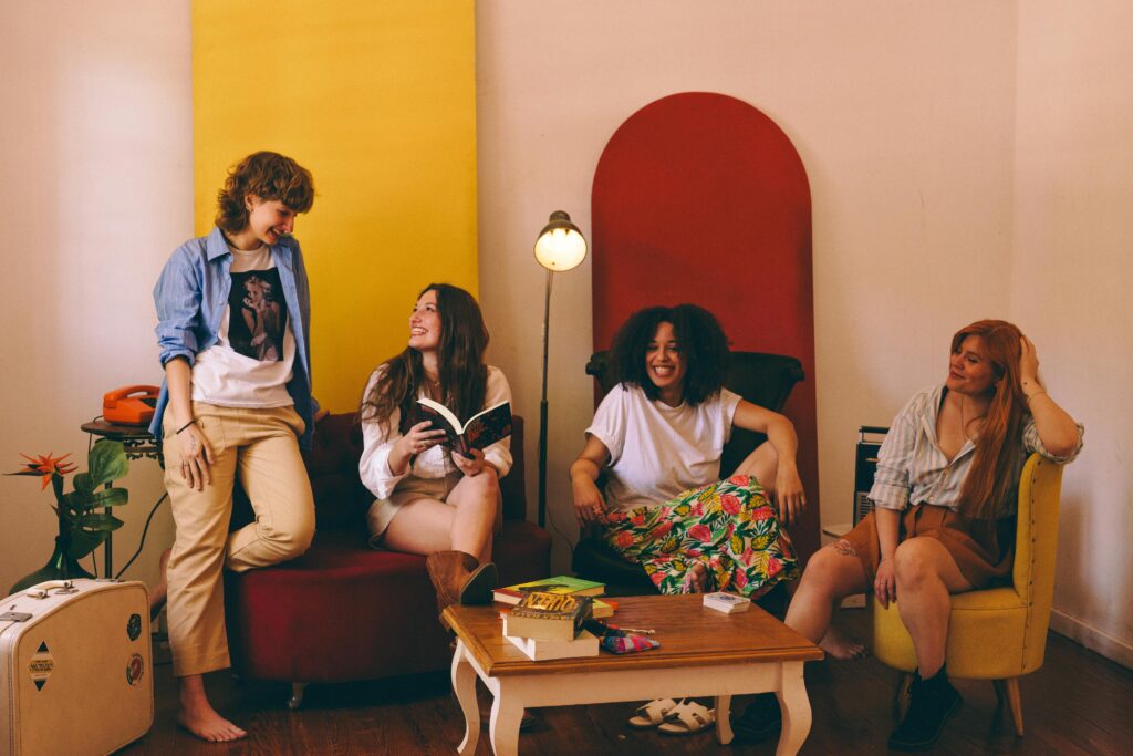 pexels photo 34967298 34967298 Four friends enjoying a relaxed gathering indoors with books and conversation.